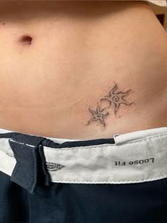 a woman's stomach with a small tattoo on it