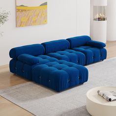 a blue couch sitting on top of a rug in a living room