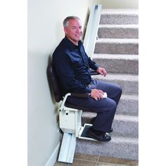 a man sitting on top of a stair lift