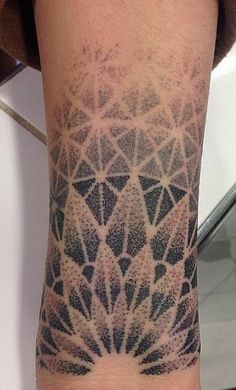 a person with a tattoo on their arm that has an intricate design in the middle