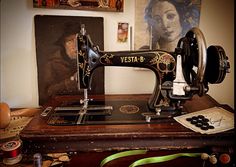 an old sewing machine sitting on top of a wooden table