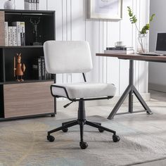 a white office chair sitting in front of a desk