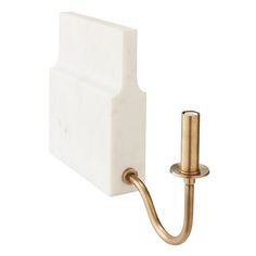 a white toilet paper holder with a gold hook on the side and a tissue dispenser attached to it