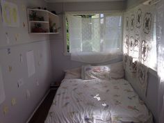 a small bedroom with a bed and window