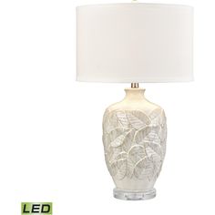 a white lamp sitting on top of a table next to a light bulb and a sign that says led