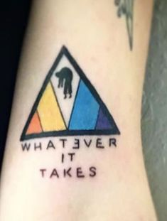 a colorful triangle with the words what ever it takes written in black ink on the side of a woman's leg