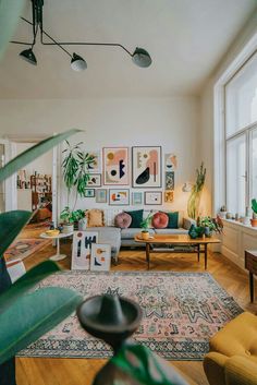 a living room filled with furniture and lots of plants