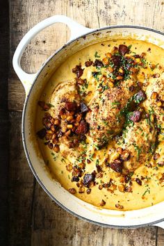 a large pot filled with food on top of a wooden table