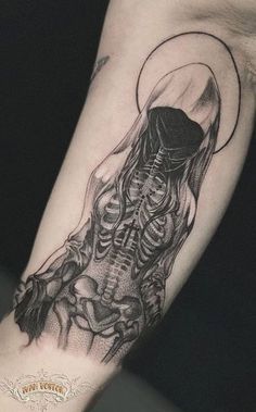 a black and white skeleton tattoo on the arm