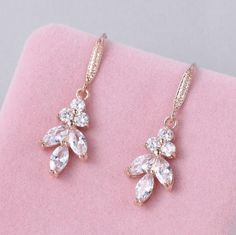 This pair of leaf-shaped crystal earrings are perfect for brides who prefer a low profile yet graceful look. It can also serve as daily earrings or the best gift for your bridesmaids. DETAILS * Color: Silver, Gold or Rose Gold Measurement: ---1 1/2 x 1/2 inches (3.5x1 cm) Material - ~ AAA grade floral cut shapes cubic zirconia ~Gold plated over copper.  ~ Nickel and lead free Wedding Dangle Earrings, Daily Earrings, Drop Earrings Wedding, Dangle Earrings Wedding, Wedding Earrings Drop, Wedding Jewelry Earrings, Wedding Headpiece, Jewelry Bridal, Earrings Wedding