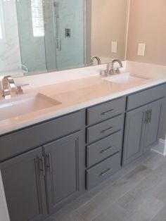 a bathroom with two sinks and a large mirror in it's center area,