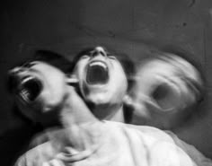 black and white photograph of two people screaming