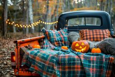 a bed with pumpkins on it in the back of an old pickup truck at night