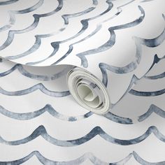 an artistic blue and white wallpaper with wavy waves on it's surface,