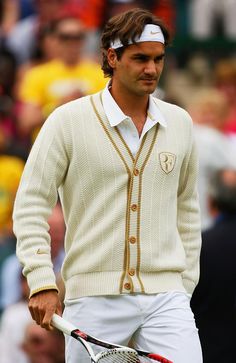 a man with a tennis racquet in his hand and a white shirt on