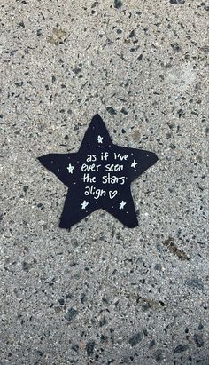 a black and white star on the ground with words written on it that says, if i live in the stars you can fly by