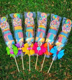 colorful candy lollipops on sticks in the grass