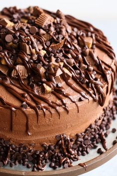 a cake with chocolate frosting and sprinkles sitting on top of a plate