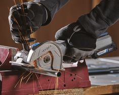 a person using a circular saw to cut wood with an angle grinder on a workbench