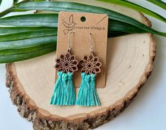 Get your free-spirit boho vibe on with these fun handmade macrame earrings!  These bohemian earrings were carefully hand knotted using soft recycled cotton cord on a wood piece. These dangle earrings are very lightweight. Makes the perfect gift for the hippie girl in your life.  Handmade with love in the USA.  *Nickel free earrings. Handmade with eco-friendly materials! I use high quality cord made from recycled cotton. Nearly all my products are made with recycled cotton or recycled polypropylene cord. I strive to be as eco-friendly as possible with all my materials and processes. ** Attention local buyers ** If you prefer to arrange for in-person pick up instead of having your item shipped to you, please message me after placing your order and I can refund any shipping costs where applic Bohemian Flower Earrings For Beach Spring, Bohemian Spring Flower Earrings For Beach, Spring Bohemian Flower Earrings For Beach, Bohemian Macrame Tassel Earrings, Turquoise Handmade Tassel Earrings For Festivals, Handmade Turquoise Tassel Earrings For Festival, Bohemian Adjustable Macrame Tassel Earrings, Bohemian Turquoise Flower Earrings Nickel Free, Handmade Bohemian Jewelry For Spring