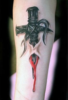 a tattoo with a cross on it and blood dripping from the cross, as well as a knife