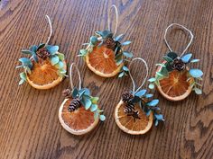 four orange slices with pine cones on them