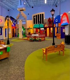 an indoor children's play area with benches and tables