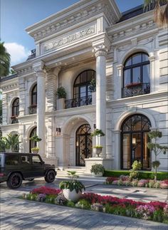 a car is parked in front of a large white building with many windows and balconies