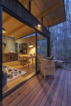 the inside of a house with wood floors and glass doors leading to an outside deck