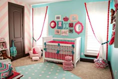 a baby's room decorated in pink, blue and white