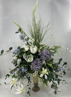 a vase filled with white and blue flowers