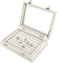 an open jewelry box with six rings in it