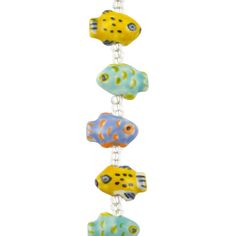 three yellow and blue fish hanging from a white beaded necklace on a silver chain