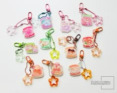 many different shaped key chains on a white surface