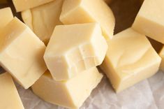 several pieces of cheese sitting on top of wax paper