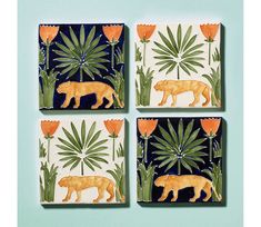 four ceramic coasters with orange and blue designs on them, each depicting a tiger