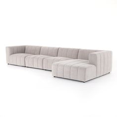 a large sectional couch sitting on top of a white floor