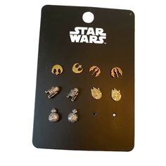 the star wars pin set is displayed on a black card with white and gold pins