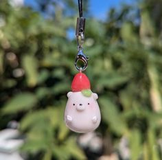 a keychain with a small plastic animal wearing a santa hat on it's head