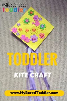 a paper kite with flowers on it and the words toddler kite craft