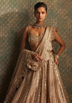 Buy Beige Gold Sequins Lehenga With Embroidered Blouse by Vvani by Vani Vats at Fabilicious Fashion! Shop made-to-measure Indian wedding wear and jewellery with fast shipping to USA, UK, and Canada. Lehenga Shoot, Tuscan Summer, Golden Lehenga, Peach Lehenga, Seema Gujral, Gold Lehenga