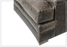 the back end of a couch with leather upholstered