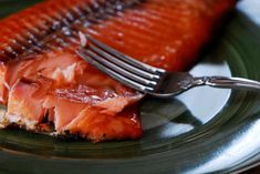 a piece of salmon on a plate with a fork