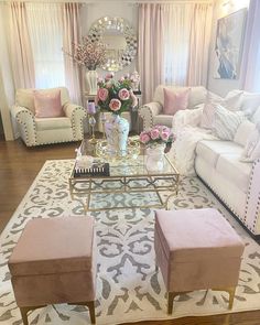 a living room filled with lots of furniture and flowers on top of a coffee table