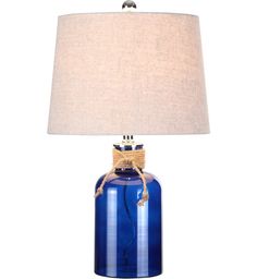 a blue glass table lamp with a rope wrapped around the base and a beige linen shade