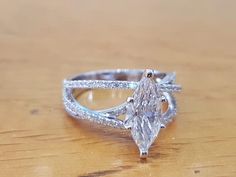 a diamond ring sitting on top of a wooden table