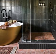 a bath tub sitting next to a walk in shower