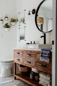 a bathroom with a sink, mirror and wooden cabinet in it's centerpiece