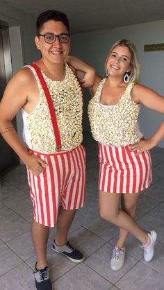 two people are dressed in red and white striped shorts, one is holding his arm around the other's shoulder