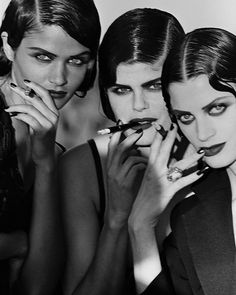 three beautiful women with makeup and manicures posing for the camera